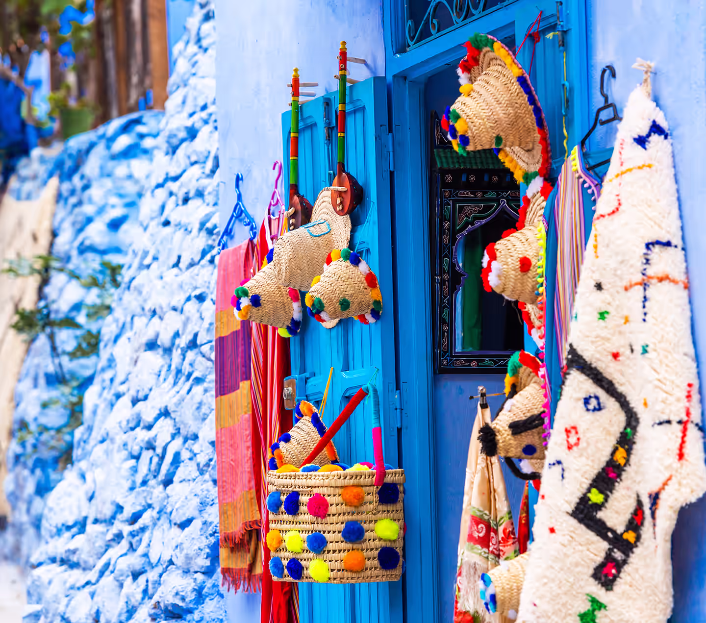 Woven hats and craft goods displayed outside a shop in Chefchaouen