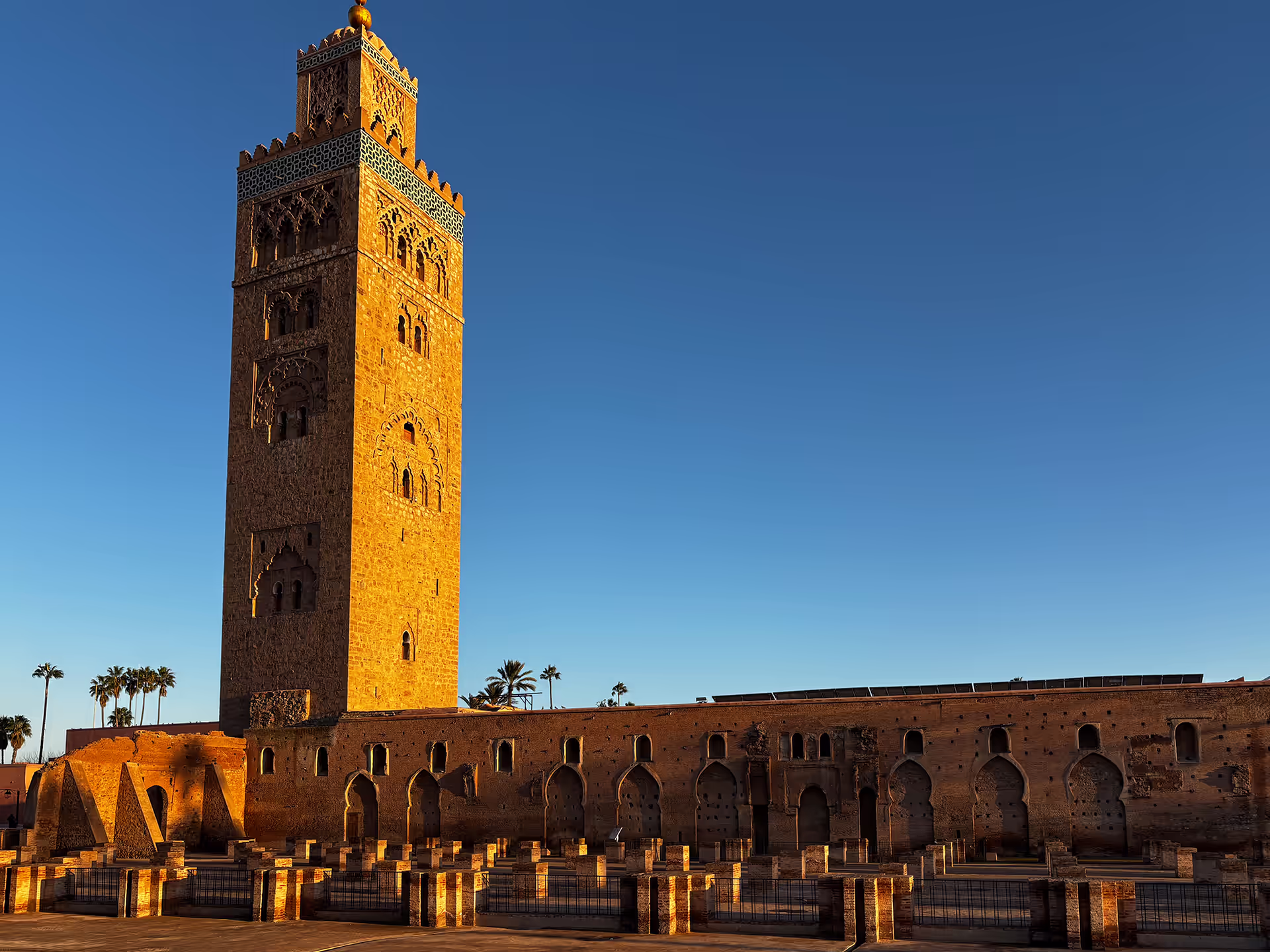 Golden sunset behind the Koutoubia mosque and its gardens in Marrakech