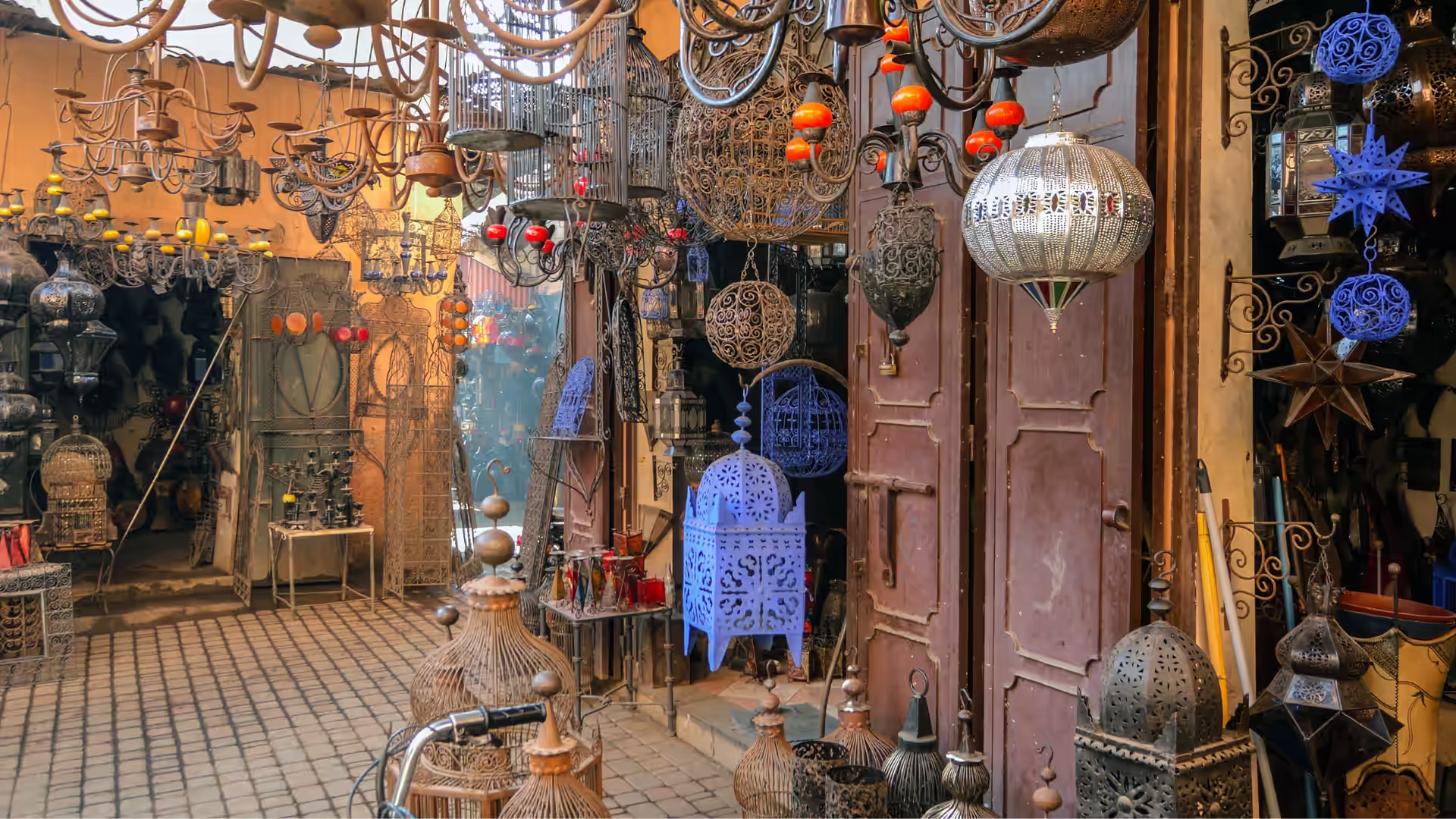 Stalls of metalwork, pottery and textiles in a Moroccan souk